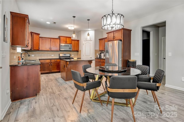 1017 Quail Run Ct, Indian Land, SC 29707 - dining space with light wood-type flooring, baseboards, and a chandelier
