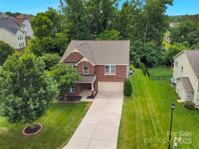 1017 Quail Run Ct, Indian Land, SC 29707 - view of front of house featuring brick siding, driveway, a garage, roof with shingles, and view of wooded area