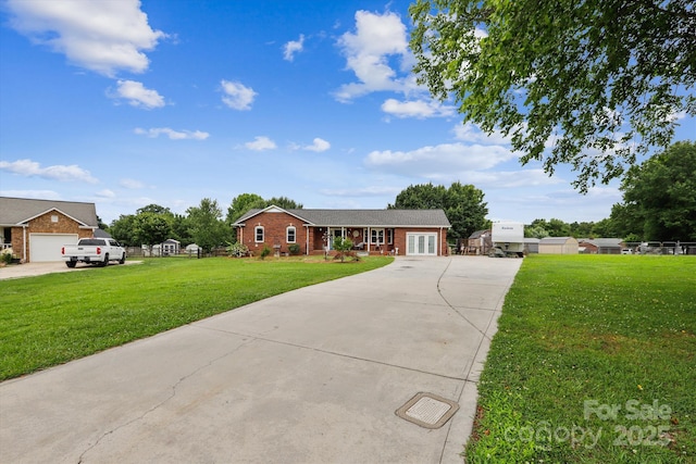 4527 Marshall Ct, Monroe, NC 28110 - ranch-style home with driveway, a front yard, brick siding, and french doors