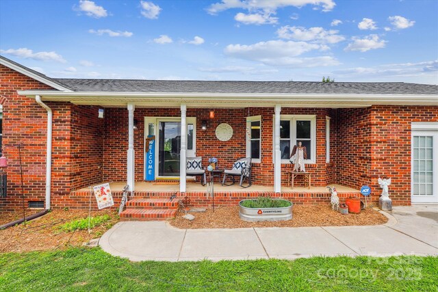 4527 Marshall Ct, Monroe, NC 28110 - property entrance featuring covered porch and brick siding