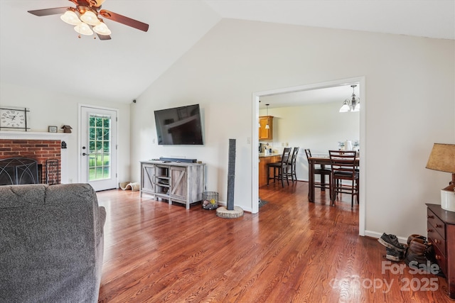 4527 Marshall Ct, Monroe, NC 28110 - living area featuring a ceiling fan, high vaulted ceiling, wood finished floors, a brick fireplace, and baseboards