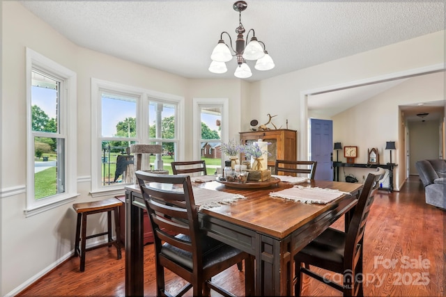 4527 Marshall Ct, Monroe, NC 28110 - dining space with a chandelier, wood finished floors, healthy amount of natural light, baseboards, and a textured ceiling