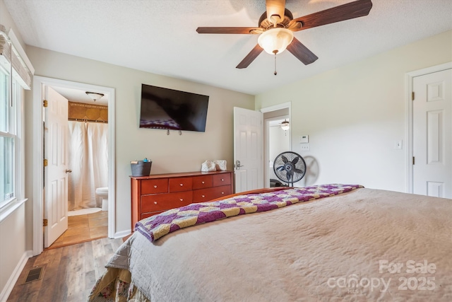 4527 Marshall Ct, Monroe, NC 28110 - bedroom with wood finished floors, multiple windows, and ensuite bath
