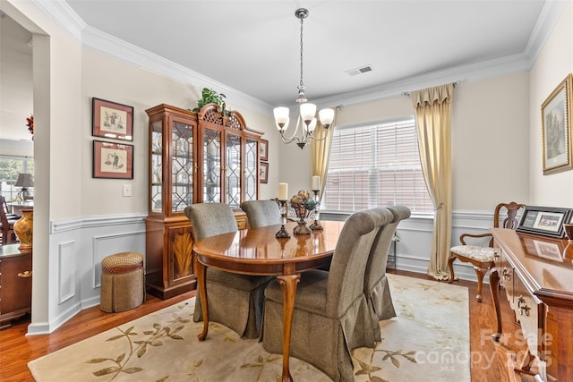 163 Carmen Way, Lancaster, SC 29720 - dining area featuring a chandelier, crown molding, a wainscoted wall, and wood finished floors