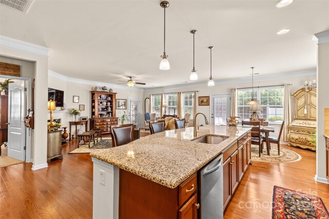 163 Carmen Way, Lancaster, SC 29720 - kitchen with a sink, stainless steel dishwasher, light wood finished floors, ornamental molding, and decorative light fixtures