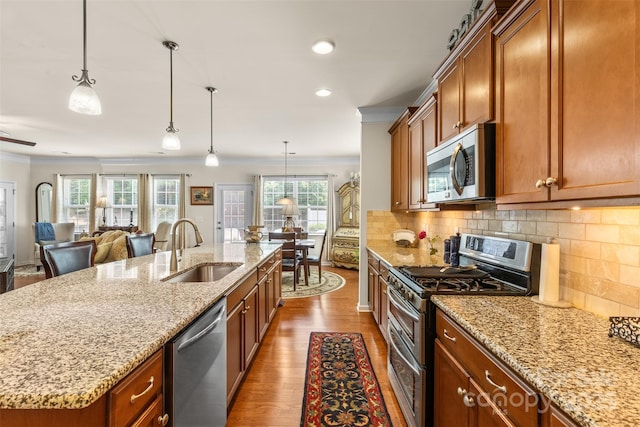 163 Carmen Way, Lancaster, SC 29720 - kitchen with appliances with stainless steel finishes, ornamental molding, a sink, brown cabinets, and dark wood finished floors