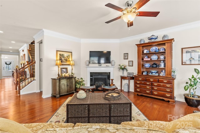 163 Carmen Way, Lancaster, SC 29720 - living area with wood finished floors, a ceiling fan, a glass covered fireplace, stairway, and ornamental molding