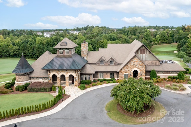 14611 Murfield Ct, Charlotte, NC 28278 - view of front of home featuring stone siding, a chimney, metal roof, golf course view, and a standing seam roof