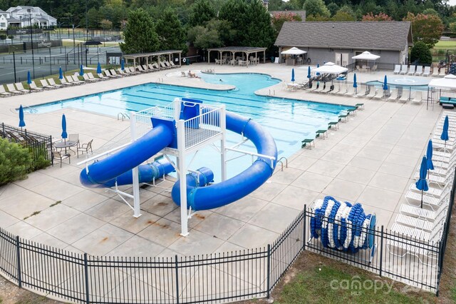 14611 Murfield Ct, Charlotte, NC 28278 - community pool with view of wooded area, a patio, and a water slide