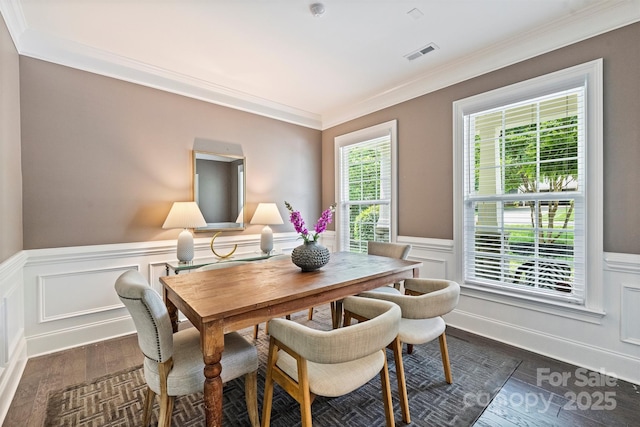 2844 Georgia Ave, Charlotte, NC 28205 - dining area with dark wood finished floors, crown molding, a wainscoted wall, and a decorative wall