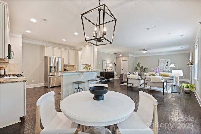 2844 Georgia Ave, Charlotte, NC 28205 - dining room with dark wood finished floors, recessed lighting, baseboards, crown molding, and a chandelier