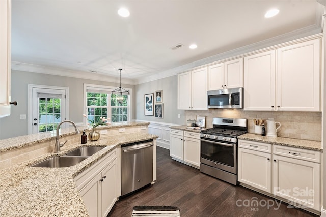 2844 Georgia Ave, Charlotte, NC 28205 - kitchen featuring appliances with stainless steel finishes, a sink, dark wood-style flooring, white cabinetry, and tasteful backsplash