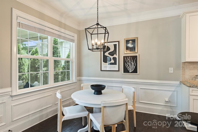 2844 Georgia Ave, Charlotte, NC 28205 - dining area with a chandelier, ornamental molding, wainscoting, a decorative wall, and dark wood-style floors