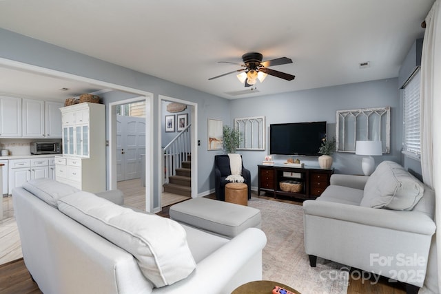318 Confederate Dr SW, Concord, NC 28027 - living room featuring stairs and a ceiling fan