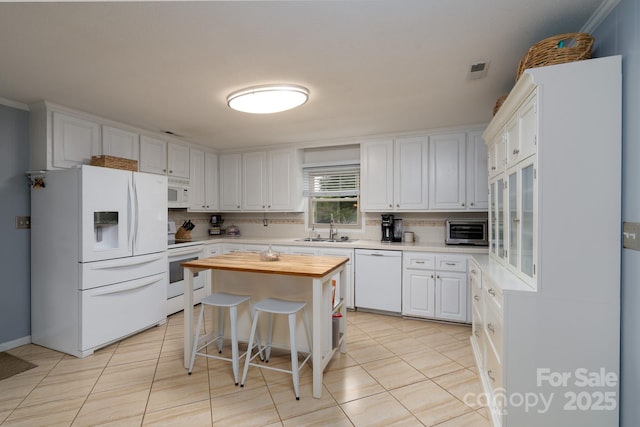 318 Confederate Dr SW, Concord, NC 28027 - kitchen with white appliances, a sink, white cabinetry, butcher block countertops, and light tile patterned flooring