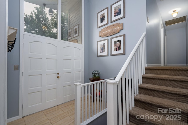318 Confederate Dr SW, Concord, NC 28027 - foyer featuring light tile patterned floors, baseboards, and stairway