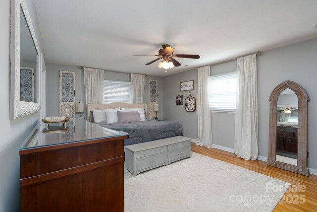 318 Confederate Dr SW, Concord, NC 28027 - bedroom with wood finished floors, a ceiling fan, and baseboards