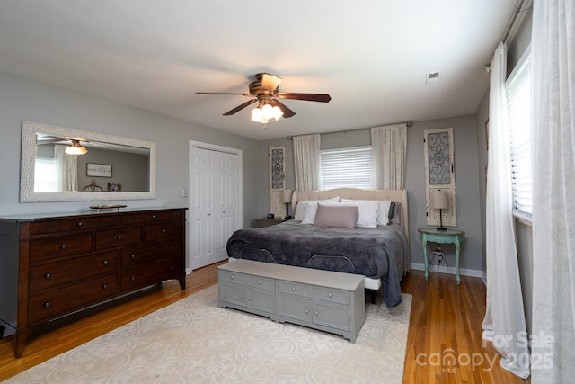 318 Confederate Dr SW, Concord, NC 28027 - bedroom with wood finished floors, a closet, and a ceiling fan