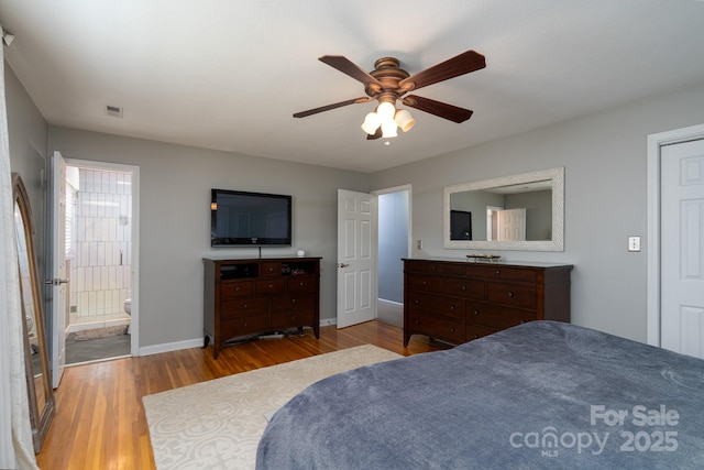 318 Confederate Dr SW, Concord, NC 28027 - bedroom featuring wood finished floors, baseboards, ceiling fan, and ensuite bathroom