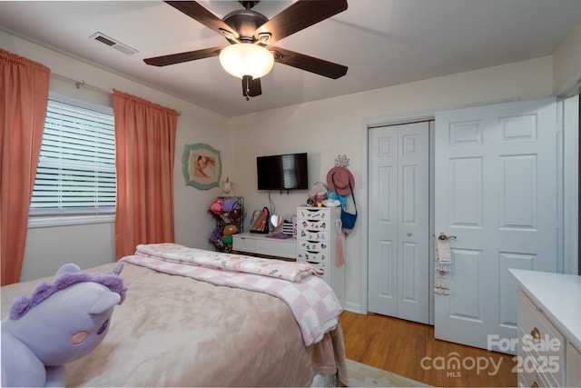 318 Confederate Dr SW, Concord, NC 28027 - bedroom with light wood-type flooring, a closet, and a ceiling fan