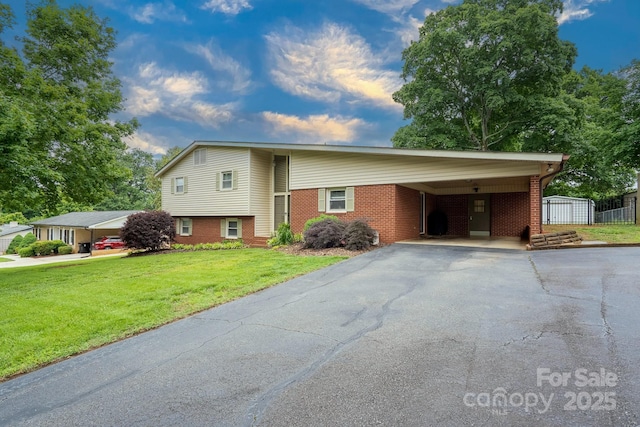 318 Confederate Dr SW, Concord, NC 28027 - split level home with driveway, brick siding, a front lawn, and an attached carport