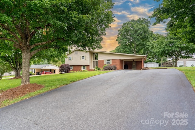 318 Confederate Dr SW, Concord, NC 28027 - split level home with driveway, brick siding, a front lawn, and an attached carport