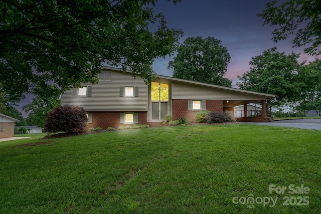 318 Confederate Dr SW, Concord, NC 28027 - view of front of home with a lawn, driveway, brick siding, and an attached carport
