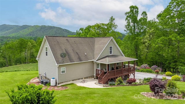 3690 Penland Rd, Spruce Pine, NC 28777 - rear view of property featuring a lawn, a deck with mountain view, a patio area, a shingled roof, and stairs