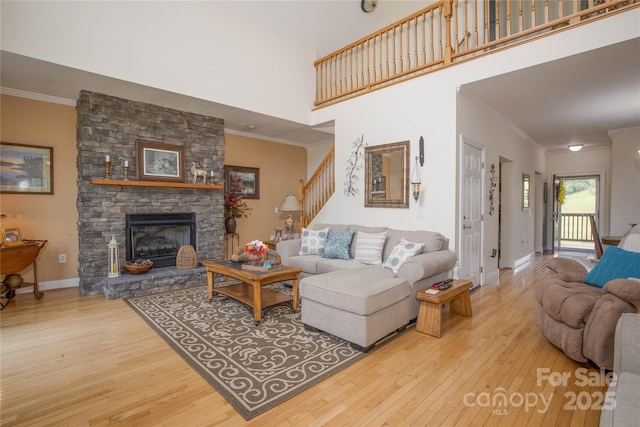 3690 Penland Rd, Spruce Pine, NC 28777 - living area with wood-type flooring, ornamental molding, baseboards, a fireplace, and a high ceiling