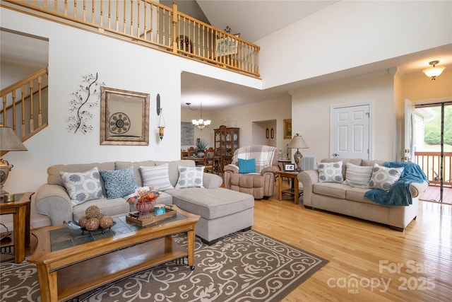 3690 Penland Rd, Spruce Pine, NC 28777 - living room featuring wood finished floors, high vaulted ceiling, a chandelier, and stairway