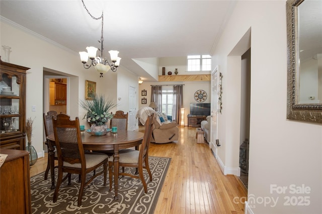 3690 Penland Rd, Spruce Pine, NC 28777 - dining space featuring crown molding, a chandelier, light wood-style flooring, and baseboards