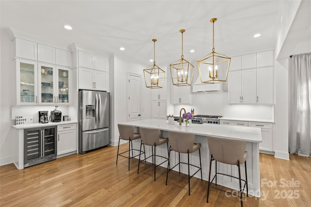 6013 Camile Ct, Charlotte, NC 28226 - kitchen with stainless steel refrigerator with ice dispenser, wine cooler, a breakfast bar, stove, and recessed lighting