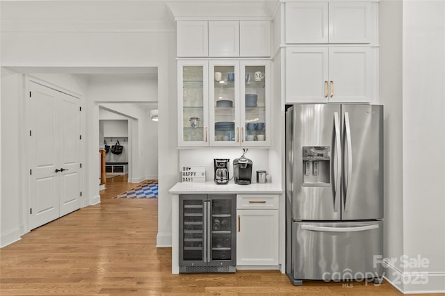 6013 Camile Ct, Charlotte, NC 28226 - indoor dry bar featuring stainless steel refrigerator with ice dispenser, beverage cooler, light wood-style flooring, and baseboards