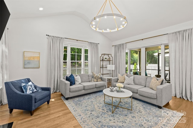 6013 Camile Ct, Charlotte, NC 28226 - living area with healthy amount of natural light, a chandelier, high vaulted ceiling, and wood finished floors