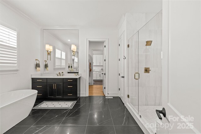 6013 Camile Ct, Charlotte, NC 28226 - bathroom with vanity, a stall shower, a soaking tub, and ornamental molding