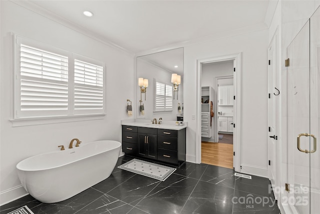 6013 Camile Ct, Charlotte, NC 28226 - bathroom featuring vanity, ornamental molding, a freestanding tub, a stall shower, and baseboards