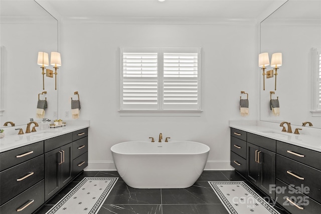 6013 Camile Ct, Charlotte, NC 28226 - bathroom with two vanities, a soaking tub, baseboards, and crown molding