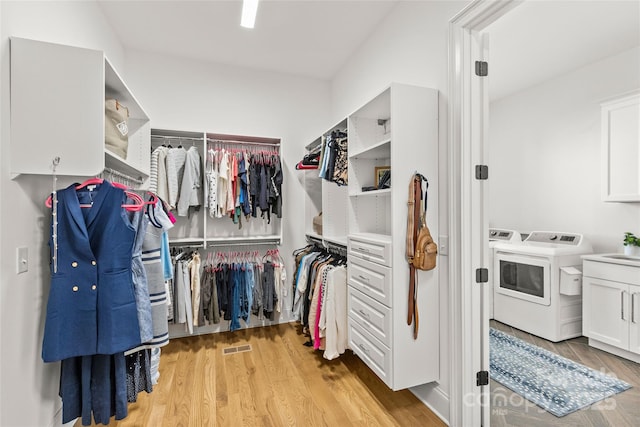 6013 Camile Ct, Charlotte, NC 28226 - walk in closet with light wood-type flooring and separate washer and dryer