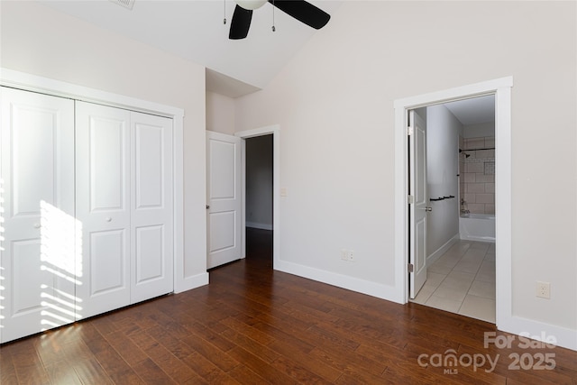 82 Wheeler Rd, Weaverville, NC 28787 - unfurnished bedroom with wood finished floors, a closet, baseboards, connected bathroom, and high vaulted ceiling