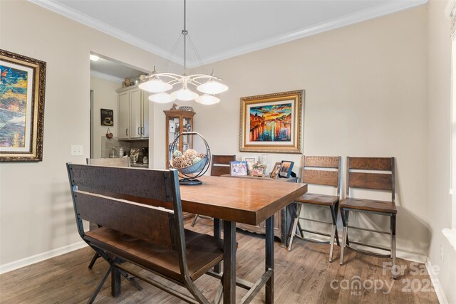 6010 Hawk View Rd, Waxhaw, NC 28173 - dining space featuring wood finished floors, baseboards, a chandelier, and crown molding