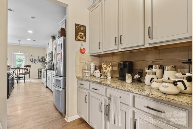 6010 Hawk View Rd, Waxhaw, NC 28173 - kitchen featuring appliances with stainless steel finishes, baseboards, backsplash, ornamental molding, and light wood-style floors