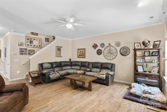 6010 Hawk View Rd, Waxhaw, NC 28173 - living room with ceiling fan, baseboards, ornamental molding, light wood-style flooring, and stairway