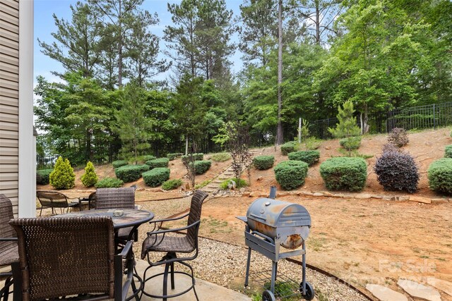 6010 Hawk View Rd, Waxhaw, NC 28173 - view of patio with a grill, outdoor dining area, and view of scattered trees