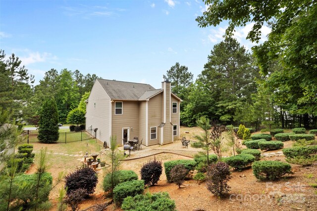 6010 Hawk View Rd, Waxhaw, NC 28173 - rear view of house featuring a chimney and a patio