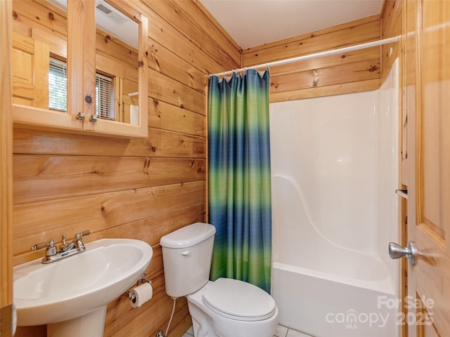 79 Acorn Ln, Rutherfordton, NC 28139 - bathroom featuring a sink, toilet, shower / bath combo with shower curtain, and wooden walls