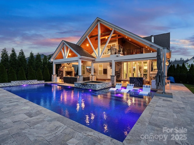 4049 Shadowbrook Rd, Waxhaw, NC 28173 - back of house with a balcony, a patio area, an outdoor living space with a fireplace, stairway, and a pool with connected hot tub