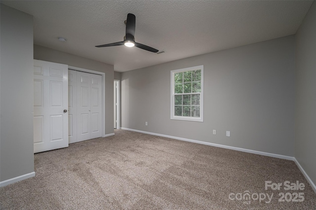 1520 28th St SW, Hickory, NC 28602 - unfurnished bedroom featuring carpet floors, baseboards, a closet, ceiling fan, and a textured ceiling