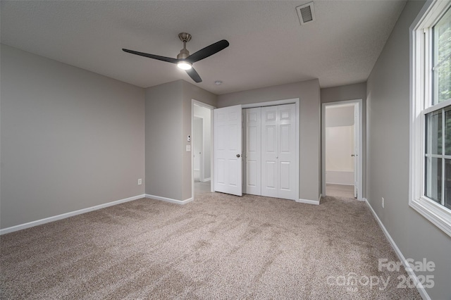 1520 28th St SW, Hickory, NC 28602 - unfurnished bedroom featuring carpet flooring, baseboards, a closet, ceiling fan, and a textured ceiling