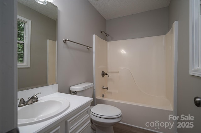 1520 28th St SW, Hickory, NC 28602 - full bath featuring a textured ceiling, vanity, toilet, tub / shower combination, and wood finished floors