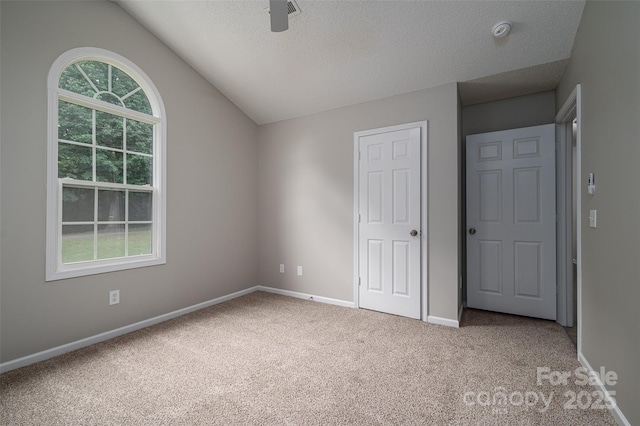 1520 28th St SW, Hickory, NC 28602 - unfurnished bedroom with carpet floors, vaulted ceiling, baseboards, a textured ceiling, and ceiling fan